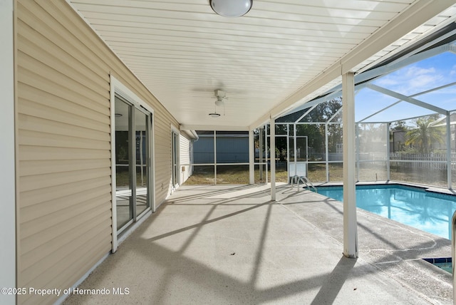 view of swimming pool featuring a lanai and a patio area