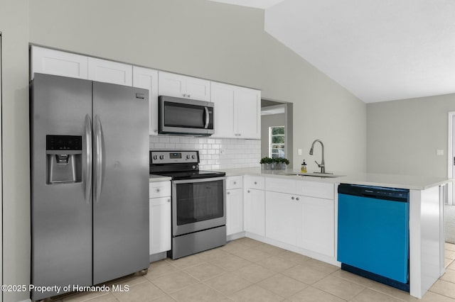 kitchen with kitchen peninsula, appliances with stainless steel finishes, and white cabinetry