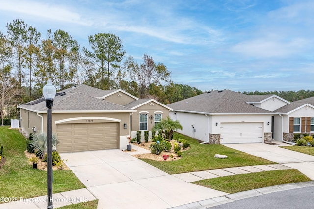 single story home with a garage and a front lawn