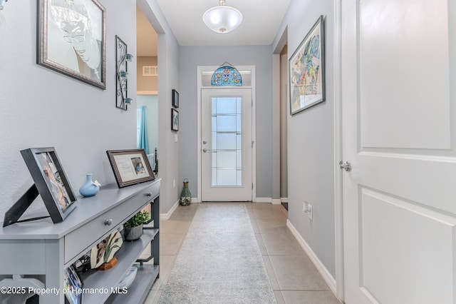 entryway featuring light tile patterned floors