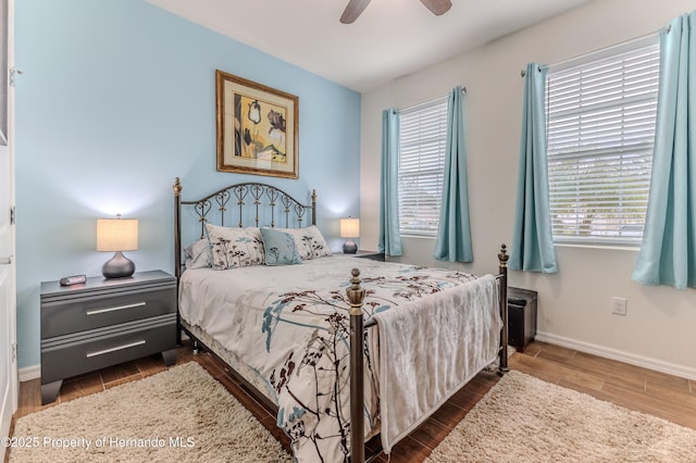 bedroom with dark wood-type flooring and ceiling fan