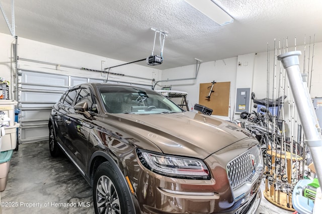 garage with a garage door opener and electric panel