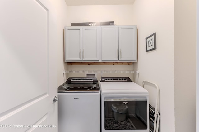 washroom featuring independent washer and dryer and cabinets