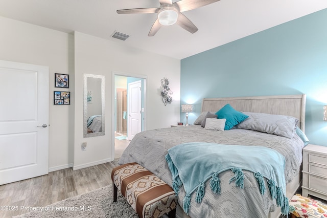 bedroom featuring ceiling fan, connected bathroom, and light hardwood / wood-style floors