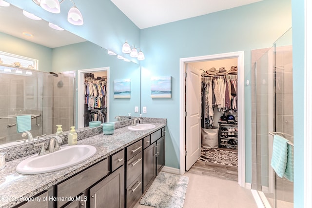 bathroom with tile patterned floors, vanity, and an enclosed shower