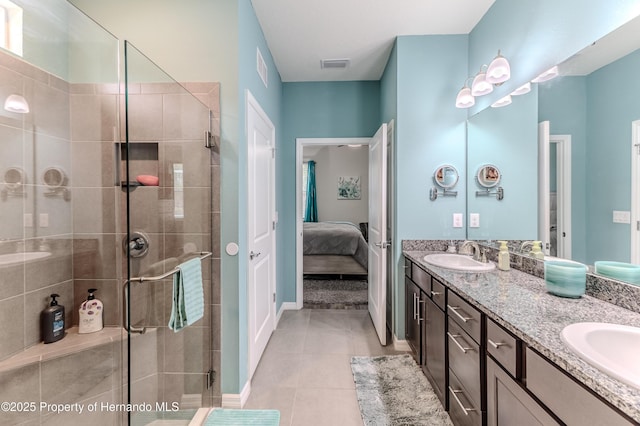 bathroom featuring tile patterned flooring, vanity, and an enclosed shower