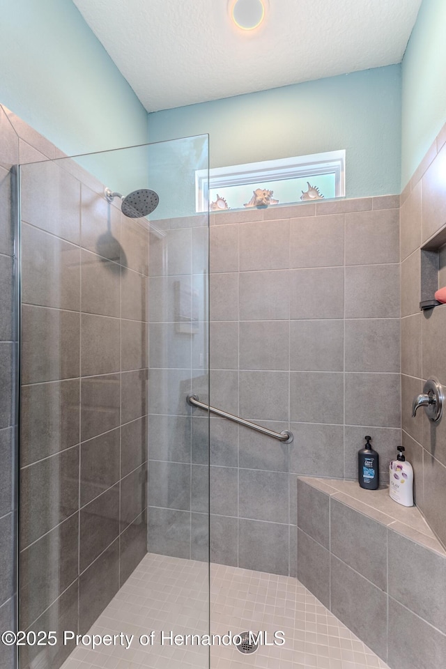 bathroom with tiled shower