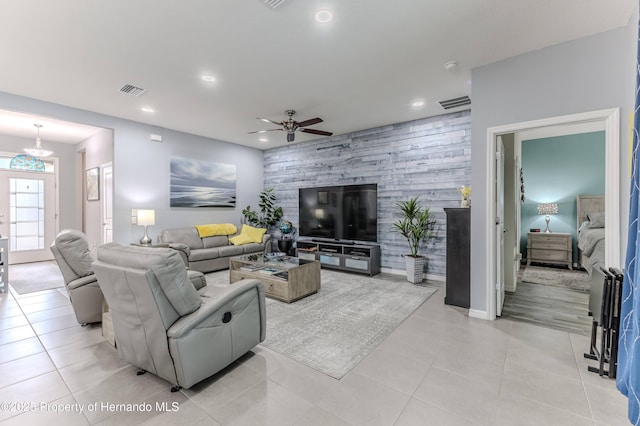 tiled living room featuring ceiling fan