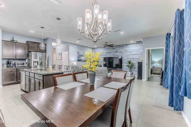 dining space featuring sink, light tile patterned floors, and ceiling fan