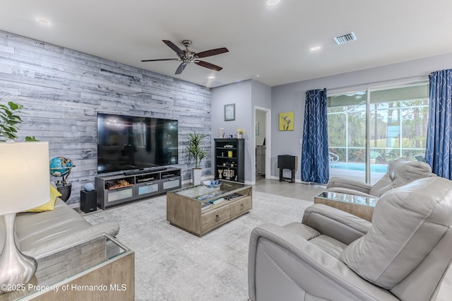 living room featuring wooden walls and ceiling fan