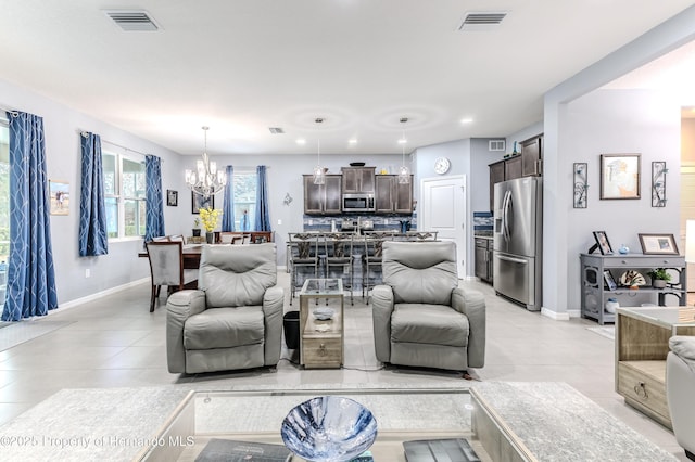 tiled living room featuring a chandelier