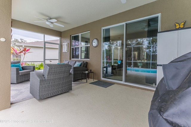 sunroom featuring ceiling fan