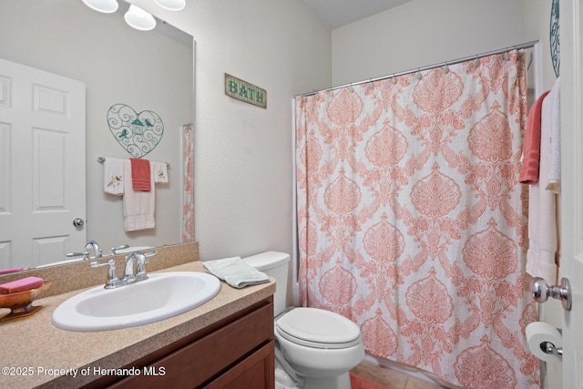 bathroom with vanity, a shower with shower curtain, and toilet