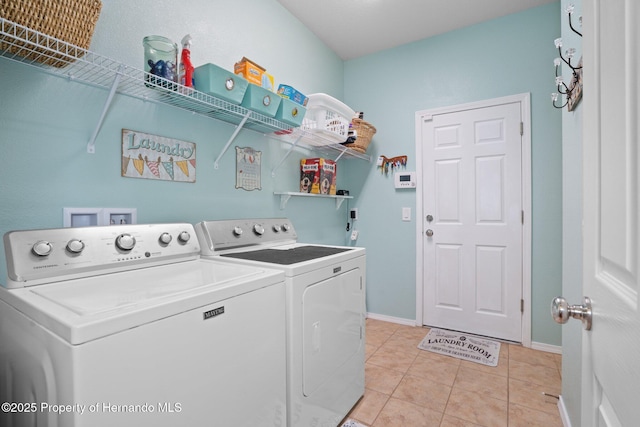 laundry room featuring light tile patterned floors and independent washer and dryer