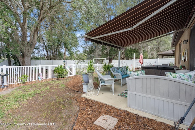 view of patio with outdoor lounge area and a hot tub