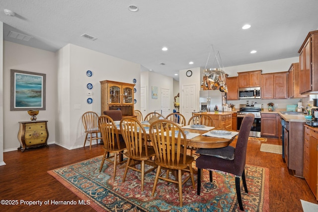 dining area with dark wood-type flooring and sink