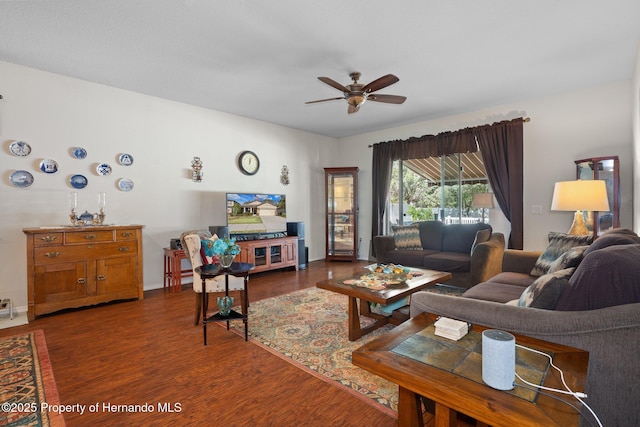 living room featuring dark hardwood / wood-style floors and ceiling fan