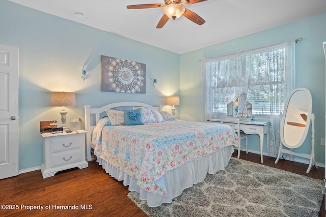 bedroom with ceiling fan and dark hardwood / wood-style floors