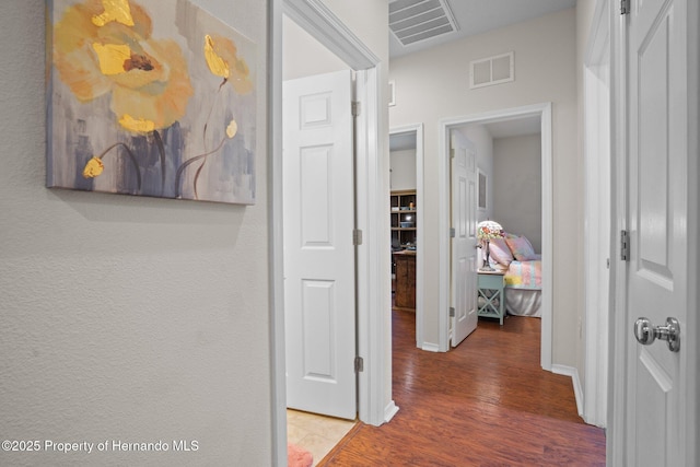 corridor featuring hardwood / wood-style floors