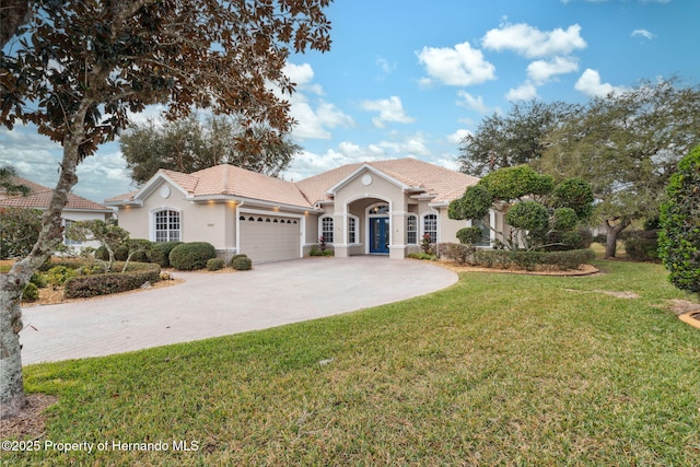 view of front of home with a garage and a front yard