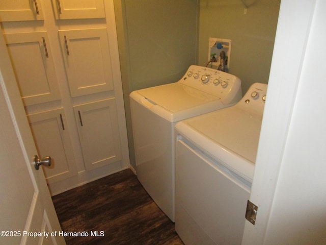 laundry room featuring washer and dryer and dark hardwood / wood-style floors