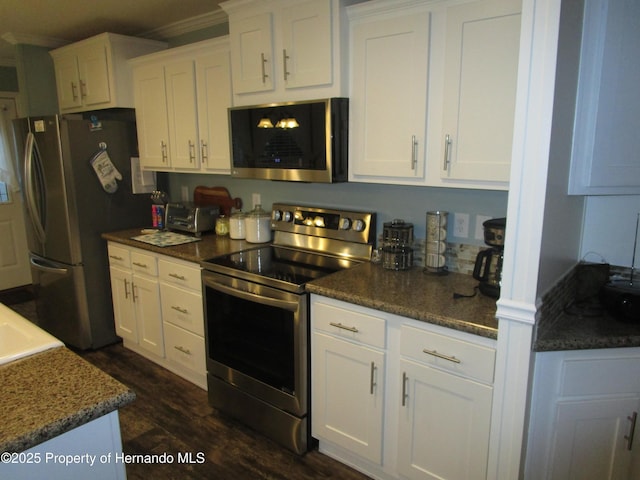 kitchen featuring stainless steel appliances and white cabinetry