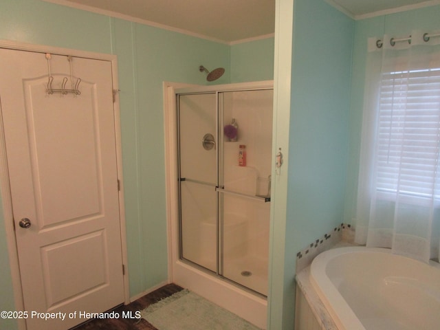 bathroom with crown molding and shower with separate bathtub