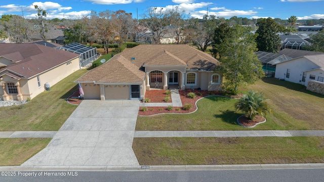 view of front of house featuring a front lawn, a residential view, driveway, and an attached garage