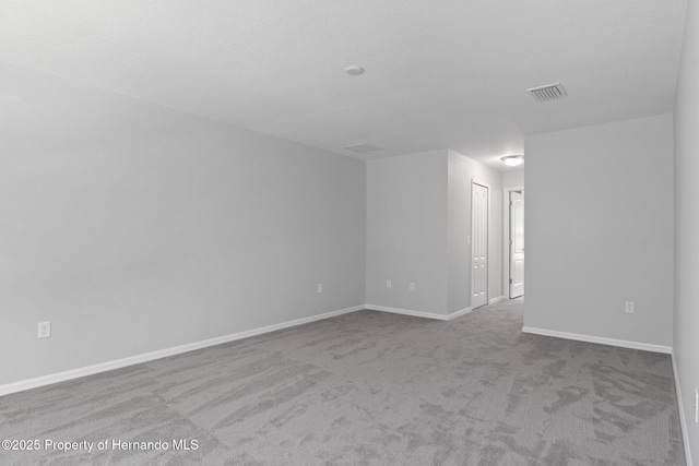 empty room featuring light colored carpet