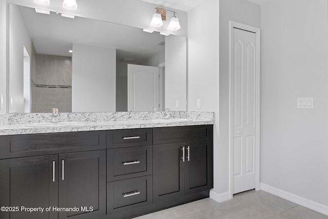 bathroom with vanity, tile patterned floors, and tiled shower