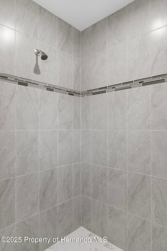 bathroom with tiled shower