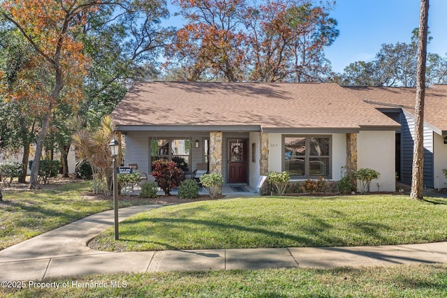 view of front of home featuring a front yard and covered porch