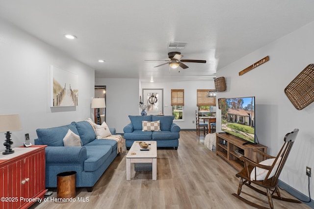 living room with ceiling fan and light hardwood / wood-style floors