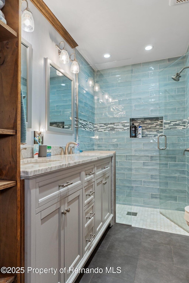 bathroom featuring ornamental molding, vanity, and a shower with shower door