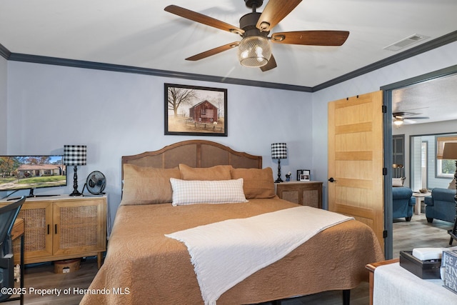 bedroom with ornamental molding and ceiling fan