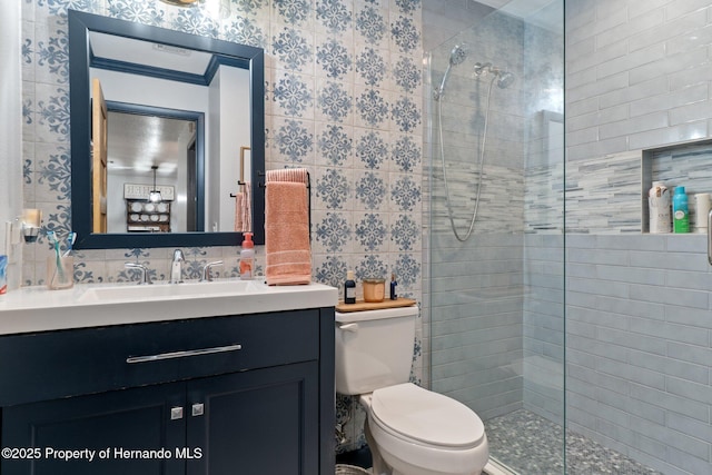 bathroom featuring toilet, an enclosed shower, tile walls, vanity, and backsplash