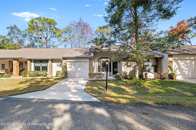 ranch-style home featuring a garage and a front lawn