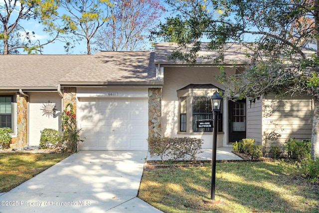 view of front of property with a garage and a front lawn