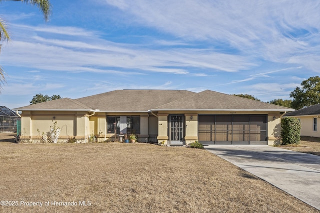 single story home featuring a garage and a front yard