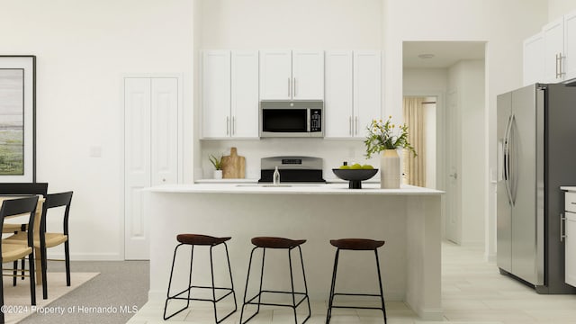 kitchen featuring appliances with stainless steel finishes, sink, white cabinets, and a kitchen breakfast bar