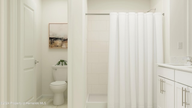 bathroom with vanity, a tile shower, tile patterned floors, and toilet