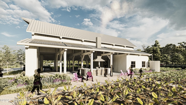 rear view of property with a patio area and exterior kitchen