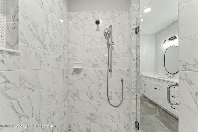 bathroom featuring vanity and tiled shower