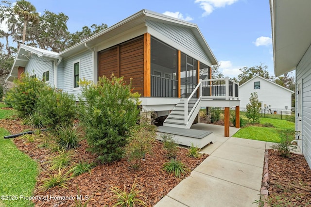 view of front of house featuring a sunroom