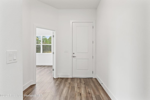 hall with light hardwood / wood-style floors