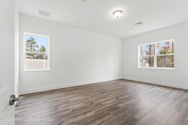 unfurnished room featuring hardwood / wood-style flooring