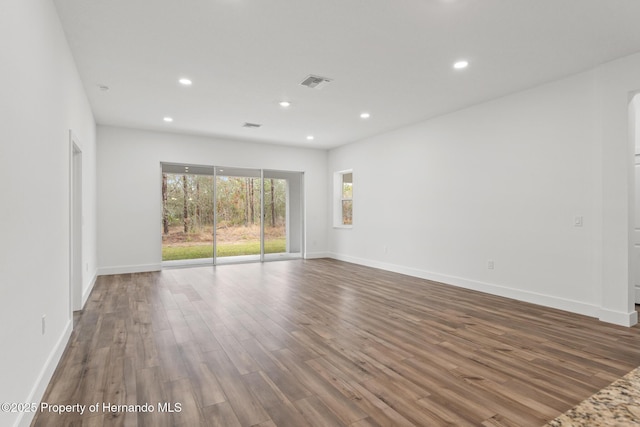 spare room with dark hardwood / wood-style flooring