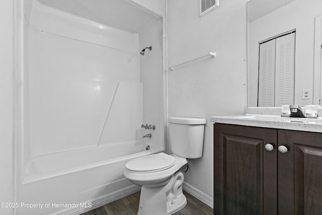 full bathroom with shower / bath combination, vanity, wood-type flooring, and toilet