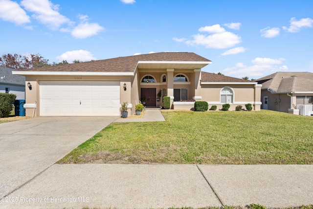 view of front of house featuring a garage and a front yard