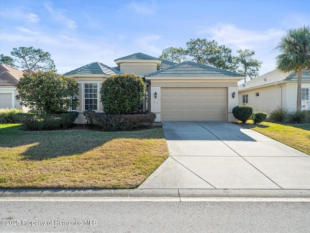 view of front of property with a garage and a front lawn